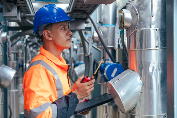 istock The technician carefully inspecting a section of pipeline during a construction project, emphasizing safety and precision in infrastructure development. 2169964325