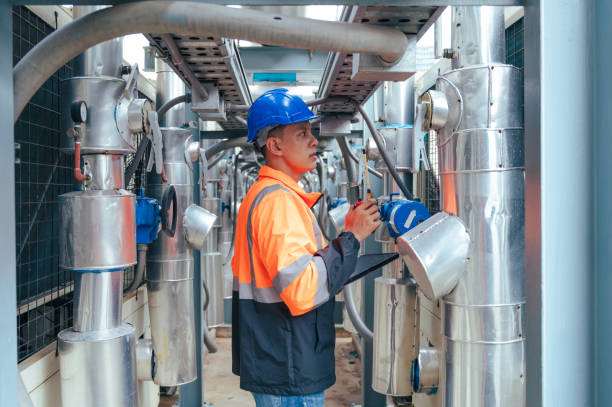 istock The technician carefully inspecting a section of pipeline during a construction project, emphasizing safety and precision in infrastructure development. 2169964327