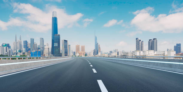 istock Empty asphalt road and modern city skyline panorama under blue sky 2169966075