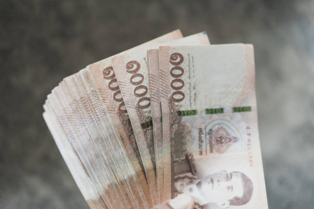 istock Many 1,000 Thai Baht banknotes held in hand 2169967197