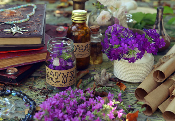 istock Mystic still life with magic book of spells, bottles and witchy ritual objects on old table. Occult, esoteric, wicca and divination concept. No foreign language, all symbols are fictional 2169967265