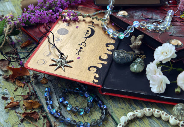istock Mystic still life with magic book of spells, amulet and witchy ritual objects on old table. Occult, esoteric, wicca and divination concept. No foreign language, all symbols are fictional 2169967283