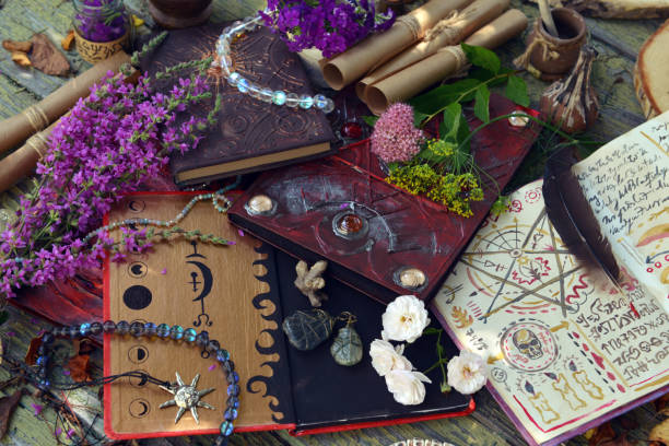 istock Mystic still life with magic book of spells, crystals and witchy ritual objects on old table. Occult, esoteric, wicca and divination concept. No foreign language, all symbols are fictional 2169967359