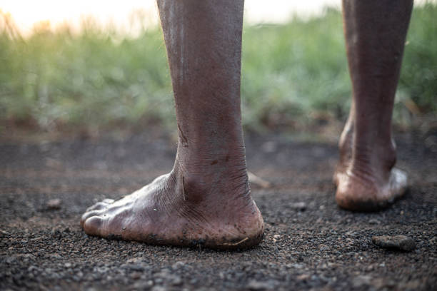 istock A man's feet are covered in mud and dirt. 2169968578