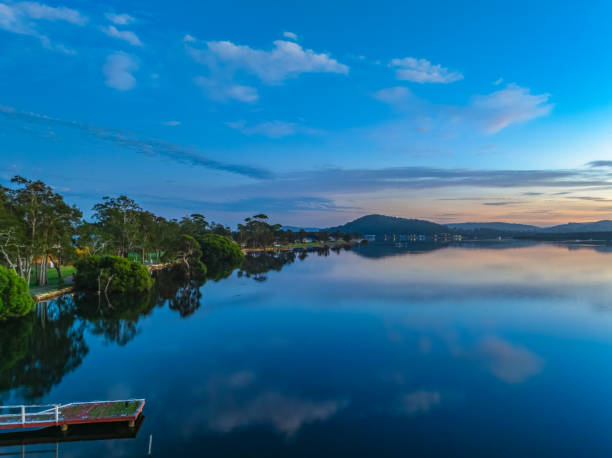 istock Sunrise along the waterfront with reflections on the bay water 2169969009