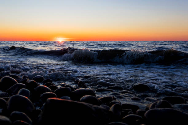 istock A beautiful sunset over the vast ocean with rocks in the foreground 2169969295