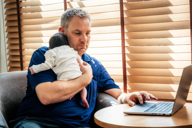 istock Father with his newborn girl working from home 2169969836