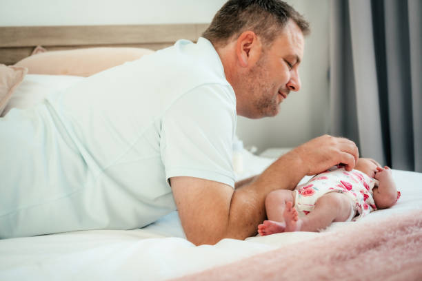 istock Father playing her young newborn girl 2169970388