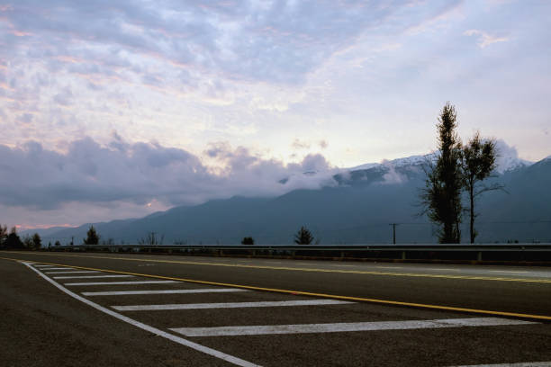 a road in south america with a cloudy sunset
