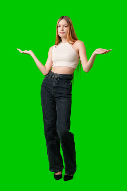 istock Young Woman Gesturing With Both Hands Against A Green Screen 2169973218