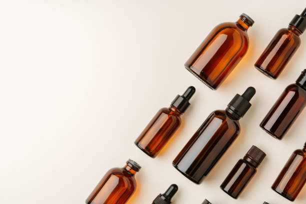 istock Various Amber Glass Containers for Essential Oils and Skin Care Products Displayed on Light Background 2169973471