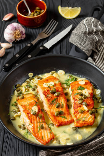 istock salmon piccata with lemon caper sauce in a pan 2169975889
