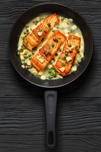 istock salmon piccata with lemon caper sauce in a pan 2169975935