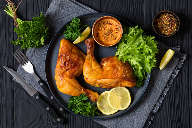 istock fried chicken legs with lettuce, lemon on plate 2169976213
