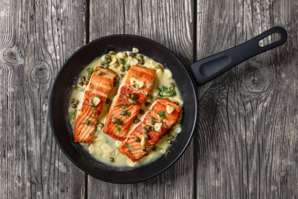 istock salmon piccata with lemon caper sauce in a pan 2169976303