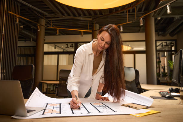 istock Female working with drawings at a desk in conference room 2169976552