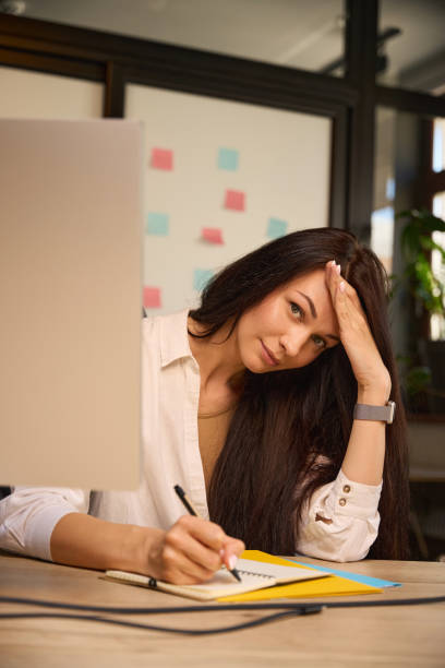 istock Young woman at her workplace in a modern coworking space 2169976617
