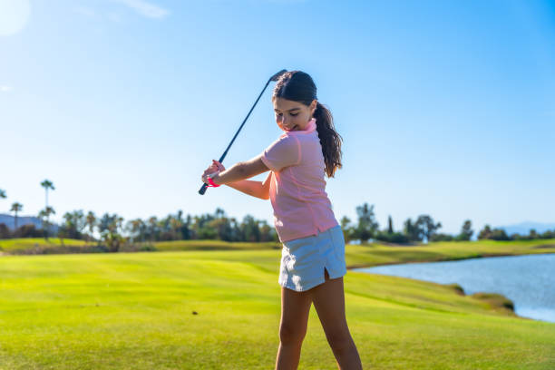 istock Girl learning how to swing golf in a course 2169979141