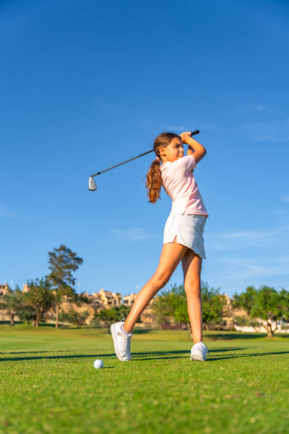 istock Girl playing golf against blue sky in a green course 2169979295