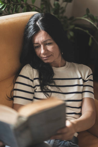 istock A woman is reading a book 2169979945