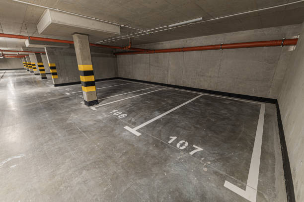 istock Empty underground multi-storey car park without cars, empty parking spaces 2169982108