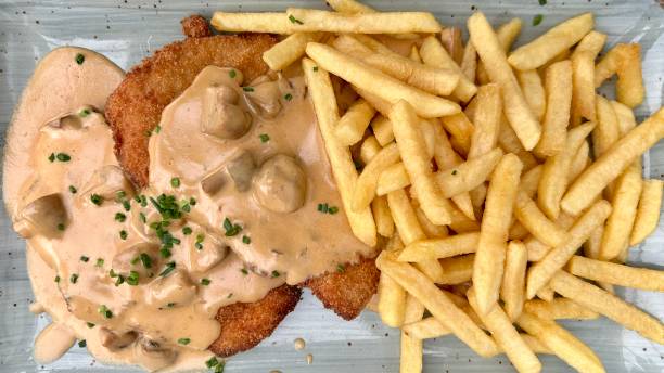Schnitzel with mushroom cream sauce and fries