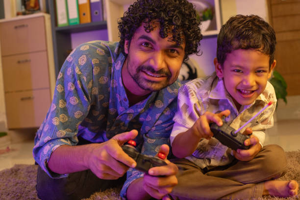 istock Cheerful father and son playing video game at home 2169986456