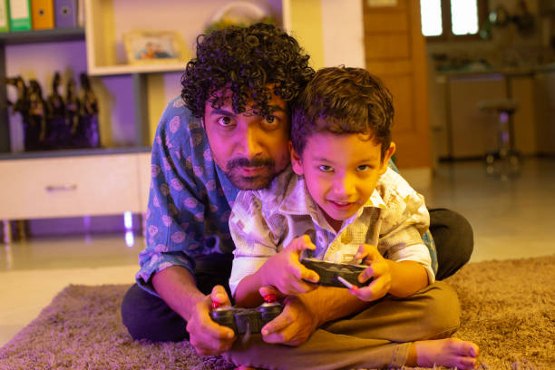 istock Cheerful father and son playing video game at home 2169986578