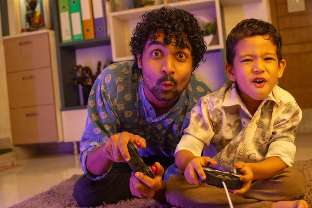 istock Cheerful father and son playing video game at home 2169986618