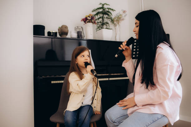 istock Mum teaches her daughter to sing at home 2169987663