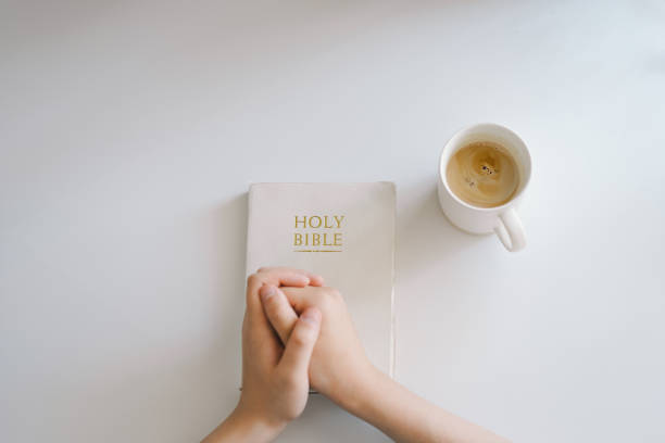 A Christian reads the Bible and drinks coffee. Reading the Holy Bible in temple. Concept for faith, spirituality and religion. Peace, hope, dreams concept