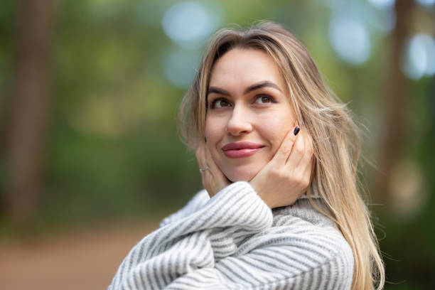 istock Young woman is daydreaming in a forest 2169995474