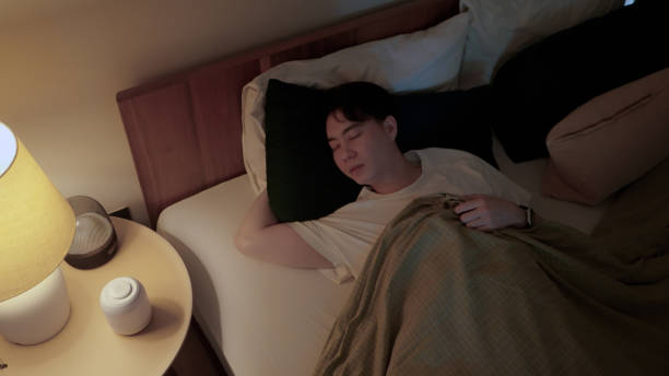 istock Asian man sleeping at night 2169996491