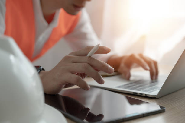istock Engineer using laptop and tablet, productivity and focus concept While this man was working on his computer 2170003480