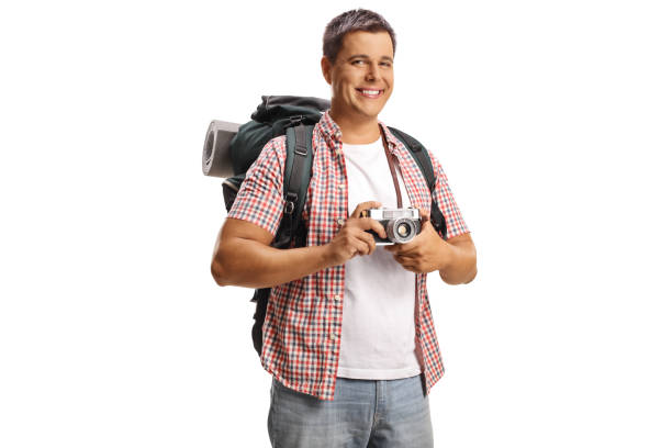 istock Male tourist with a backpack taking a photo with a camera 2170005519