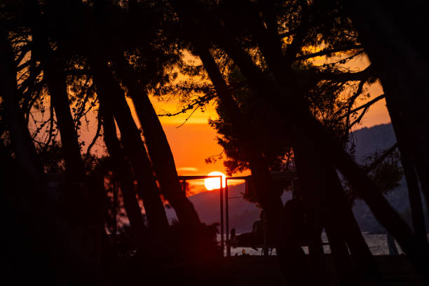 Sun is setting on the sea at Zlatni rat beach.Bol - Brac island - Croatia.