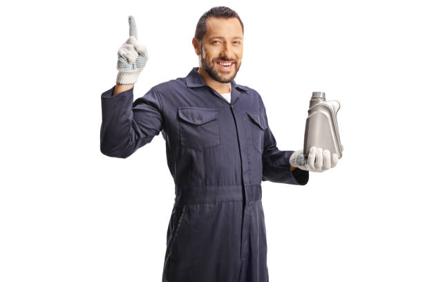 istock Car mechanic holding an engine oil plastic bottle and pointing up 2170007292