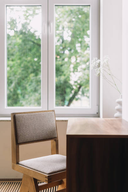 istock A minimalist workspace featuring a wooden desk and a comfortable chair 2170007949