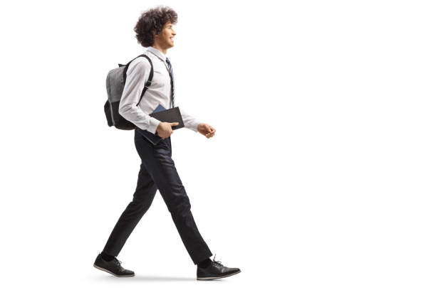 istock College student carrying a book and walking 2170010110