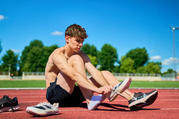 istock A man is sitting on the ground with his feet propped up 2170010887