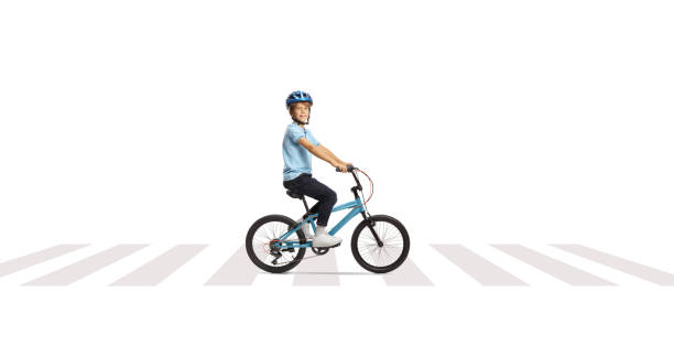 istock Happy boy riding a bicycle at a pedestrian crossing 2170010965