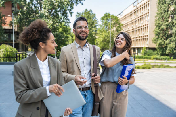 istock Three diverse business people working and talking focused and thoughtful seriously outside office building, male and female, discussing plans and work project. Businessman and businesswoman teamwork. 2170011347
