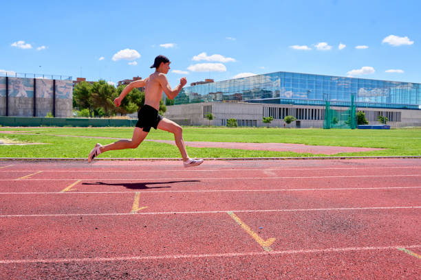 istock A man running on a track with a building in the background 2170011374