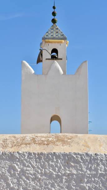 istock White Minaret behind Whitewashed Wall in Rural Tunisia 2170012138
