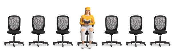 istock Office chairs and a young female reading a book 2170013510