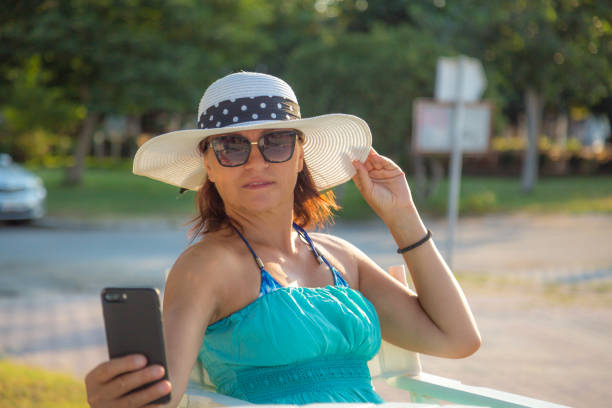 A woman at the beach in the morning enjoying the morning air and sun