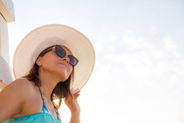 istock Sunrise serenity at the beach with a hat and warm rays 2170015448