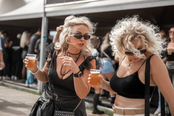Two beautiful senior female friends enjoying downtime together at a daytime dance event