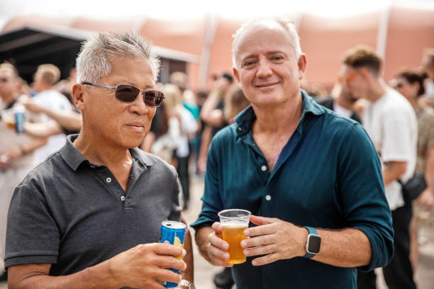 Small group of diverse senior friends enjoying downtime together at a daytime dance event