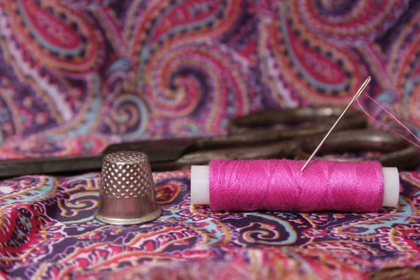 istock Hot Pink Thread on Vintage Pink and Purple Satin 2170016061